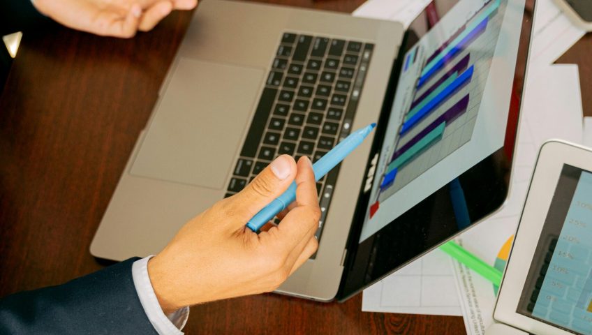 Free A Person in Black Suit Holding a Pen Stock Photo